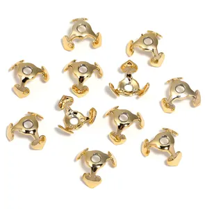 Detailed close-up of gold heart-shaped bead caps and spacer findings for DIY jewelry making.