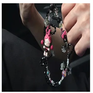 Handmade beaded phone charm strap with cute cartoon character pendant and black acrylic beads.