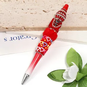 Gorgeous rhinestone beaded ballpoint pen with skull charm and vibrant hearts for writing.