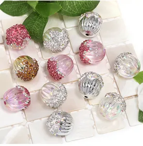 Detailed shot of sparkling rhinestone acrylic pumpkin beads and DIY charm accessories.