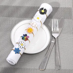 Set di portatovaglioli in metallo con fiori di cartone animato per la tavola.