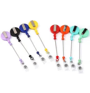 Vue détaillée de porte-badges rétractables colorés avec clips métalliques pratiques.