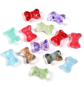 Close-up detail of colorful glass bowknot beads, transparent DIY jewelry making charms.