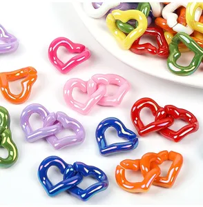Close-up of colorful glossy acrylic heart chain links for DIY jewelry accessories making.