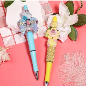 Handmade DIY beaded ballpoint pen set with rhinestones, pearls and cute charms for creative writing.