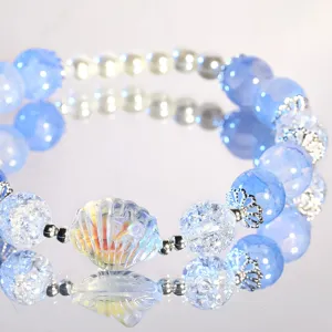 Blue glass beaded bracelet with shell charm and crystal cracked beads for DIY jewelry making.