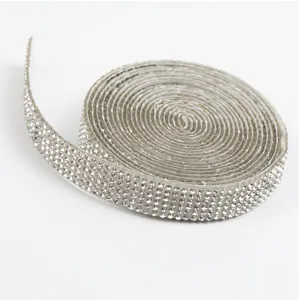 Close-up detail of silver rhinestone ribbon roll, self-adhesive crystal mesh trim for DIY.
