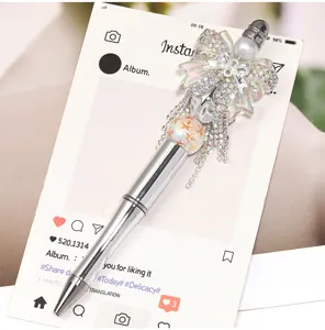 Rhinestone bow metal decorative pen crystal pearl bead detail close-up view accessory.