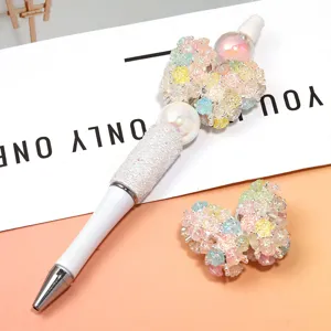 Penne con perline fai-da-te fatte a mano con fiori in resina colorata e ciondoli a farfalla.