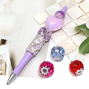 DIY beaded ballpoint pen featuring sparkling rhinestones and crystal beads for accessories.