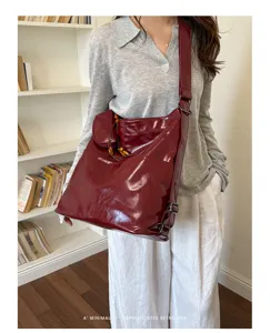 Close-up detail view of a stylish burgundy PU leather convertible backpack and tote.