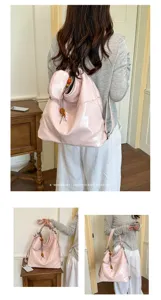 Detailed view of glossy pink PU leather backpack, showing multiple carrying ways and wooden beads.
