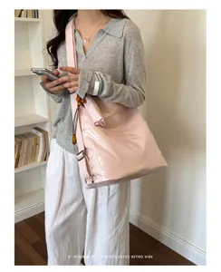 Detailed showcase of the stylish pink PU leather convertible shoulder bag worn in a cozy room.