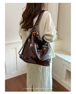 Dark brown PU leather convertible backpack and shoulder bag, stylish commuter tote detail.