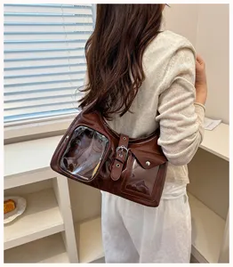 Details of brown PU leather crossbody ita bag with clear window pockets and vintage buckle strap.