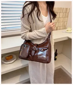 Chic dark brown patent leather shoulder bag with clear pocket design, trendy casual crossbody bag.