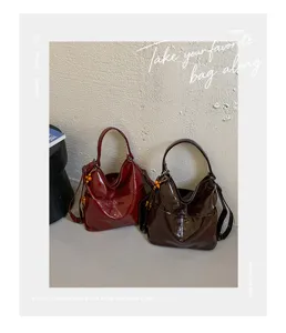 PU leather casual hobo shoulder bag with front pocket and chic beaded charm details.