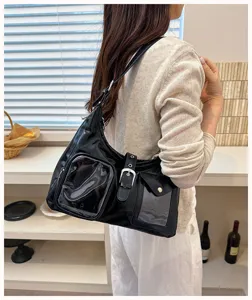 Black patent leather shoulder bag with clear front pockets, stylish designer handbag for daily use.
