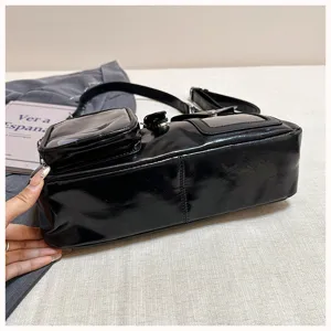 Black patent leather crossbody bag with multiple pockets and adjustable strap for daily use.