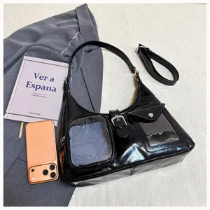 Black patent leather shoulder bag with clear pocket and metal buckle for daily fashion trends.