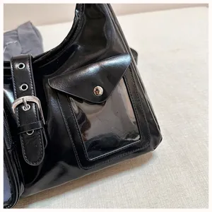 Black glossy shoulder crossbody bag with buckle strap and front transparent pocket detail.