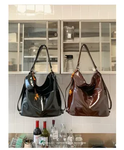 Close-up detail of stylish dual-use PU leather shoulder and crossbody bag with glossy finish.
