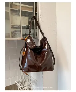 Dark brown shiny PU leather women backpack, versatile shoulder crossbody commute bag for daily use.
