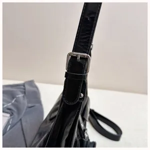 Black PU leather shoulder bag detail, adjustable metal buckle strap, niche trendy design.