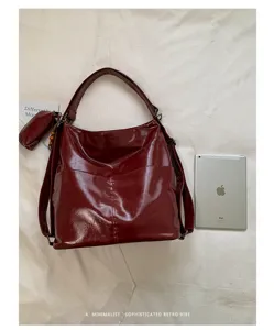 Detailed view of the burgundy PU leather convertible shoulder bag and backpack with front pocket.