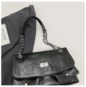 Schwarze gesteppte Ketten-Umhängetasche mit Metallriemen und praktischen Taschen.