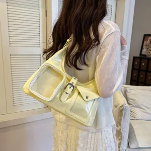 Trendy light yellow shoulder bag with transparent pocket, stylish crossbody bag for women daily use.