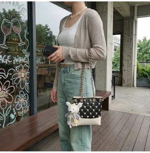 Chic black white bucket bag with sparkling rhinestones and cute plush charm for women.