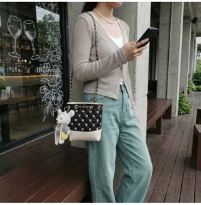Chic Korean style quilted bucket bag with chain strap and cute bear pendant for daily wear