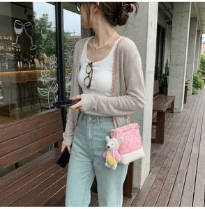 Chic Korean style pink quilted bucket bag with chain strap and cute plush pendant for daily commute.