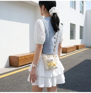 Chic casual crossbody bucket bag with cute plush bear pendant, perfect for everyday styling.