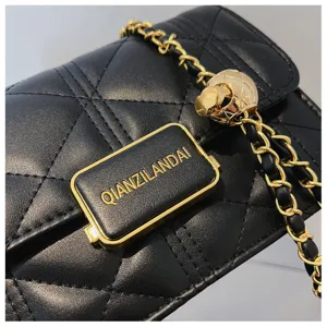 Black quilted chain crossbody bag for women, luxury style small square handbag with metal strap.
