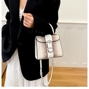 Detailed view of the retro snakeskin top-handle bag featuring chic metal buckle design.