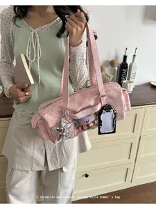 Detailed view of the pink star-printed ita shoulder bag with transparent window and charms.