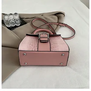 Pink retro embossed top handle handbag, stylish crossbody bag with metal lock and strap.