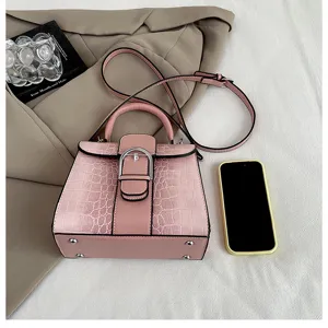 Vintage pink PU leather handbag with crocodile pattern, elegant top handle and shoulder strap.