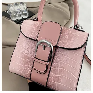 Pink crocodile pattern top handle bag with iconic buckle design for women. Elegant retro shoulder bag.