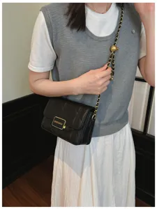 Black quilted chain shoulder bag for women, classic style designer crossbody handbag.