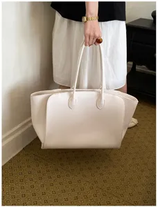 Detailed view of the white leather tote bag, showing fine texture, perfect for daily commute.