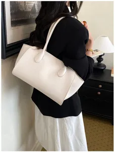 Stylish white leather shoulder tote bag for women, large capacity commute underarm bag.