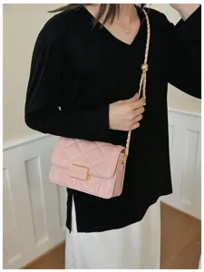 Pink quilted shoulder bag with gold chain strap, elegant women's crossbody daily accessory.