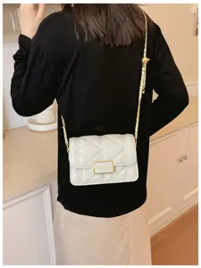 White quilted shoulder bag with gold chain strap, elegant small square crossbody bag daily style.