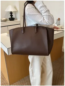 Detailed view of the large capacity leather commuter tote bag in dark brown, stylish and useful.