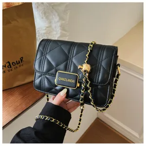 Black quilted chain shoulder bag for women, luxury designer style handbag with metal plaque.