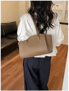 Detail shot of a stylish brown leather tote bag, perfect for daily commute and casual wear.