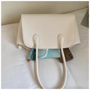 Detailed view of large capacity white tote shoulder bag showing inner space with daily items.